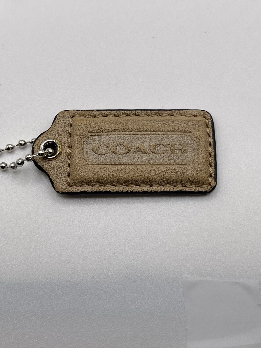 COACH Leather Hang Tag Keychain in Taupe